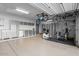 Well-organized garage with epoxy flooring, storage cabinets, and exercise equipment at 32020 N 20Th Dr, Phoenix, AZ 85085