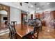 Kitchen and dining area featuring stone accents, granite countertops, stainless steel appliances, and dining table at 32020 N 20Th Dr, Phoenix, AZ 85085