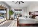 Bright main bedroom features wood floors, outdoor access, and luxurious bedding at 32020 N 20Th Dr, Phoenix, AZ 85085