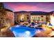 Backyard pool area with a stone waterfall feature, spa, and patio perfect for outdoor relaxation and entertainment at 32020 N 20Th Dr, Phoenix, AZ 85085