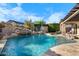 Gorgeous backyard with a freeform pool, rock waterfall, and mature landscaping offering a private escape at 32020 N 20Th Dr, Phoenix, AZ 85085