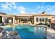 Backyard paradise featuring a large pool, rock details, and a covered patio for ultimate outdoor relaxation at 32020 N 20Th Dr, Phoenix, AZ 85085