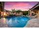 Beautiful swimming pool with rock waterfall feature and colorful sunset backdrop at 32020 N 20Th Dr, Phoenix, AZ 85085
