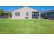 Lush backyard featuring manicured lawn, covered patio, garden beds and white fence at 32729 N Mach Ln, San Tan Valley, AZ 85143