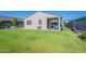 Lush backyard featuring manicured lawn, covered patio, garden beds and white fence at 32729 N Mach Ln, San Tan Valley, AZ 85143