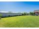 Large grassy backyard with garden beds and privacy wall for relaxing and entertaining at 32729 N Mach Ln, San Tan Valley, AZ 85143