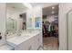 Modern bathroom featuring double sinks, a large mirror, and a walk-in closet at 32729 N Mach Ln, San Tan Valley, AZ 85143