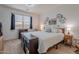 Bright bedroom with a queen-size bed, modern decor, and ample natural light at 32729 N Mach Ln, San Tan Valley, AZ 85143