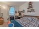Cozy bedroom with a comfortable bed, window with blinds, and decorative shelving for books and plants at 32729 N Mach Ln, San Tan Valley, AZ 85143