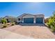 Well-maintained house with a three-car garage and desert landscaping in a sunny neighborhood at 32729 N Mach Ln, San Tan Valley, AZ 85143