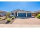 Charming single-story home with a three car garage and beautifully landscaped front yard at 32729 N Mach Ln, San Tan Valley, AZ 85143
