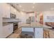 Bright kitchen with an island and granite countertops, modern stainless appliances at 32729 N Mach Ln, San Tan Valley, AZ 85143