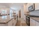 Open concept kitchen with granite countertops, island seating, and modern appliances at 32729 N Mach Ln, San Tan Valley, AZ 85143