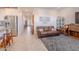 Open concept living room featuring tile floors, a comfortable leather sofa, and neutral decor at 32729 N Mach Ln, San Tan Valley, AZ 85143