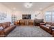 Spacious living room with a comfortable leather sofa, piano, and decorative wall art at 32729 N Mach Ln, San Tan Valley, AZ 85143