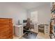 Functional home office space with a desk, comfortable chair, storage drawers, and shelving for books and supplies at 32729 N Mach Ln, San Tan Valley, AZ 85143