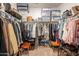 Organized walk-in closet featuring double hanging rods, shelving, and storage containers for maximum storage capacity at 32729 N Mach Ln, San Tan Valley, AZ 85143