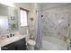 Bathroom with a marble vanity, decorative mirror, and a tiled shower with a bathtub at 3581 S Arizona Pl, Chandler, AZ 85286