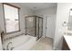 Bright bathroom featuring a soaking tub, glass enclosed shower, and decorative tile accents at 3581 S Arizona Pl, Chandler, AZ 85286