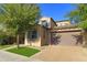 Charming two-story home showcasing a well-manicured lawn, desert landscaping, and a brick-paved driveway leading to a two-car garage at 3581 S Arizona Pl, Chandler, AZ 85286