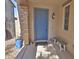 Inviting front porch with stone pillar, a light blue door, bench, and potted plants at 3581 S Arizona Pl, Chandler, AZ 85286