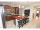 Modern kitchen with dark wood cabinets, stainless steel appliances, and a central island at 3581 S Arizona Pl, Chandler, AZ 85286