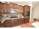 Kitchen showcasing granite countertops, stainless steel microwave, and dark wood cabinetry at 3581 S Arizona Pl, Chandler, AZ 85286