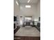 Spacious living room with high ceilings, fireplace, and abundant natural light from large windows at 3581 S Arizona Pl, Chandler, AZ 85286