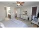 Comfortable main bedroom with hardwood floors, neutral tones, ceiling fan, and attached bathroom at 3581 S Arizona Pl, Chandler, AZ 85286