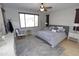 Bedroom featuring hardwood floors, soft lighting, a ceiling fan, and neutral decor at 3581 S Arizona Pl, Chandler, AZ 85286