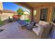 Inviting covered patio with comfortable seating and views of the landscaped backyard at 3581 S Arizona Pl, Chandler, AZ 85286