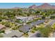 Aerial view of the home, showcasing a neighborhood, nearby pool, and mountainous backdrop at 4010 E Coolidge St, Phoenix, AZ 85018