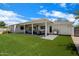 Charming backyard showcasing a covered patio, a built-in grill and a beautiful artificial lawn at 4010 E Coolidge St, Phoenix, AZ 85018