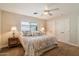 Well-lit bedroom with carpet, a window, and closet doors offering organized storage solutions at 4010 E Coolidge St, Phoenix, AZ 85018