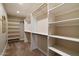 A spacious walk-in closet featuring custom shelving, hanging rods, and ample storage space for an organized wardrobe at 4010 E Coolidge St, Phoenix, AZ 85018
