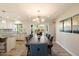 Elegant dining area with a chandelier overlooking the spacious open floorplan and a view to the backyard at 4010 E Coolidge St, Phoenix, AZ 85018