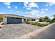 Wide driveway leading to a charming home with a two-car garage and a well-maintained lawn at 4010 E Coolidge St, Phoenix, AZ 85018