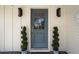 Stylish front door with decorative plants adding a touch of elegance to the home's entrance at 4010 E Coolidge St, Phoenix, AZ 85018