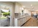 Well-lit kitchen with white cabinets, granite countertops, and access to outdoor dining at 4010 E Coolidge St, Phoenix, AZ 85018