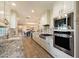 Open-concept kitchen with stainless steel appliances and sleek white cabinets at 4010 E Coolidge St, Phoenix, AZ 85018