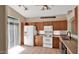 White appliances and wood cabinets in a bright kitchen at 4167 E Hallihan Dr, Cave Creek, AZ 85331