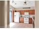 A bright kitchen with wood cabinets and all white appliances at 4167 E Hallihan Dr, Cave Creek, AZ 85331