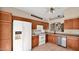 A view of the kitchen showing white appliances, dark countertops, and wood cabinets at 4167 E Hallihan Dr, Cave Creek, AZ 85331