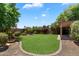 Beautifully landscaped backyard with a manicured lawn, mature plants, and a serene, inviting atmosphere at 4223 E Danbury Rd, Phoenix, AZ 85032