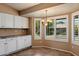 Bright dining area featuring modern lighting, white cabinets, and window shutters at 4223 E Danbury Rd, Phoenix, AZ 85032