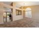 The dining area boasts neutral colors and plush carpet, creating a cozy atmosphere at 4223 E Danbury Rd, Phoenix, AZ 85032