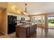 Kitchen with island, white cabinets, and a breakfast nook with a view of the backyard at 4223 E Danbury Rd, Phoenix, AZ 85032
