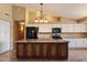 Kitchen with a center island, white cabinets, and black appliances at 4223 E Danbury Rd, Phoenix, AZ 85032