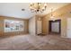 A spacious living area features large windows, carpet floors and neutral paint at 4223 E Danbury Rd, Phoenix, AZ 85032