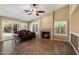 Comfortable living room featuring a fireplace, tile floors, and sliding glass doors at 4223 E Danbury Rd, Phoenix, AZ 85032